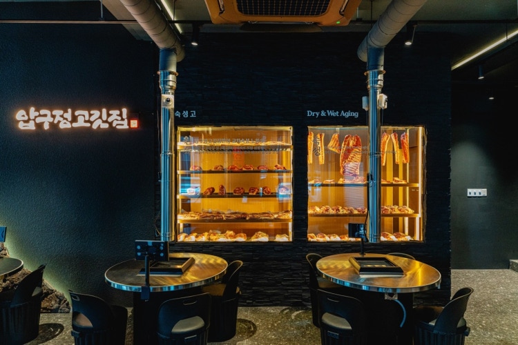 Sizzling Korean pork BBQ on a charcoal grill at Apgujeong Gogi-jip