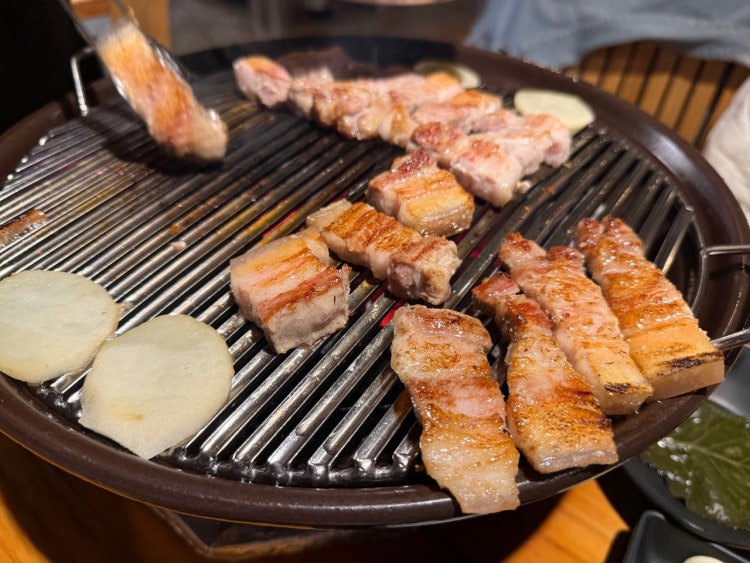 Premium Korean beef BBQ slices marbled and sizzling at Udoncheong